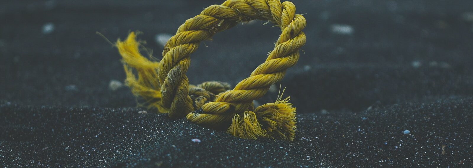 yellow rope on black sand