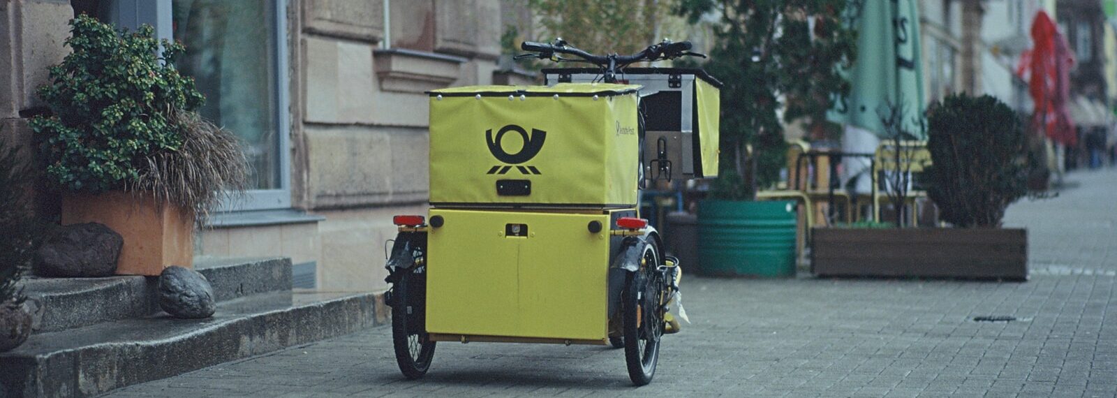 black bicycle parked beside yellow box